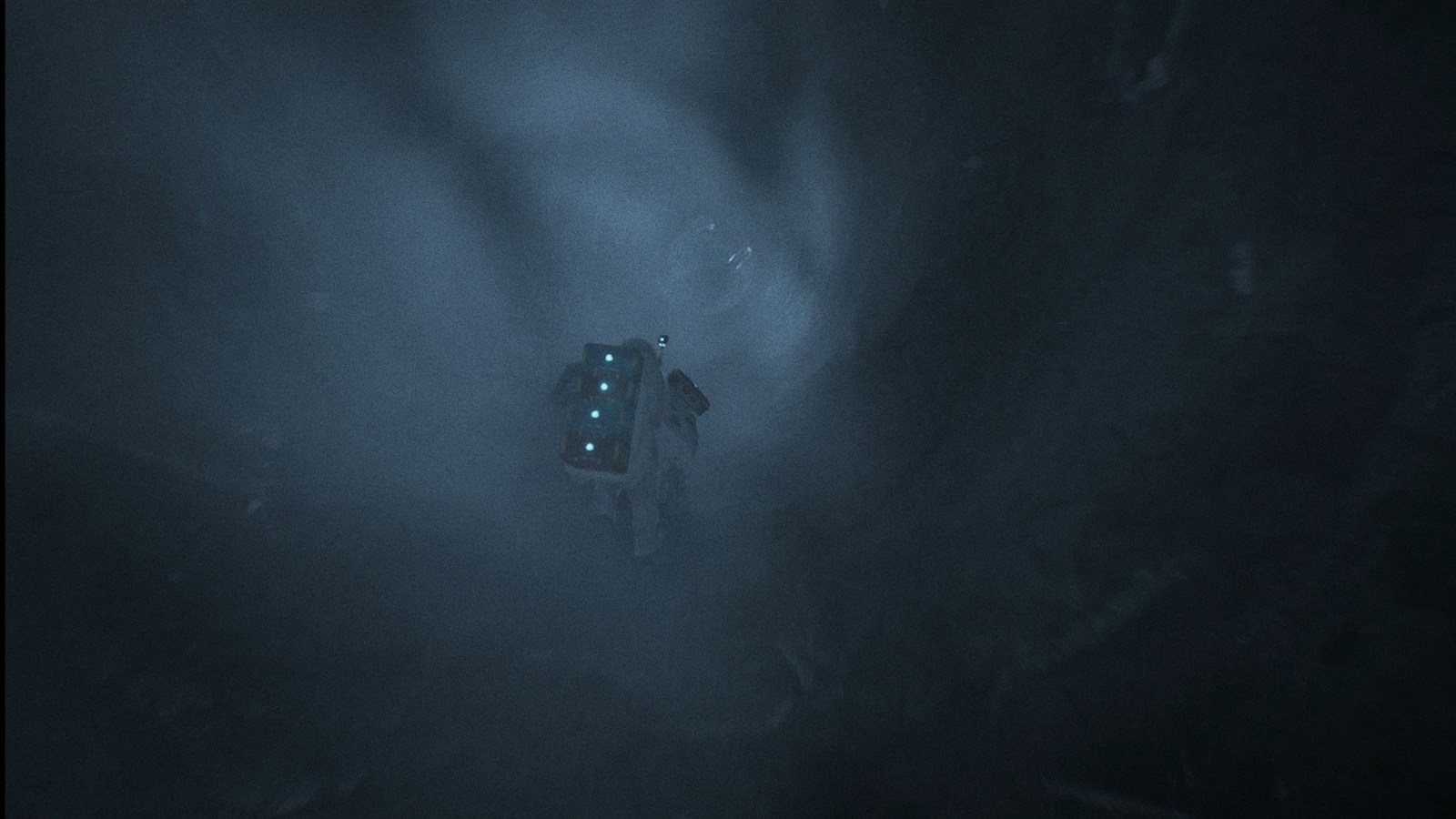 The player almost lost in a dense, dust-filled haze, lit only by suit lights